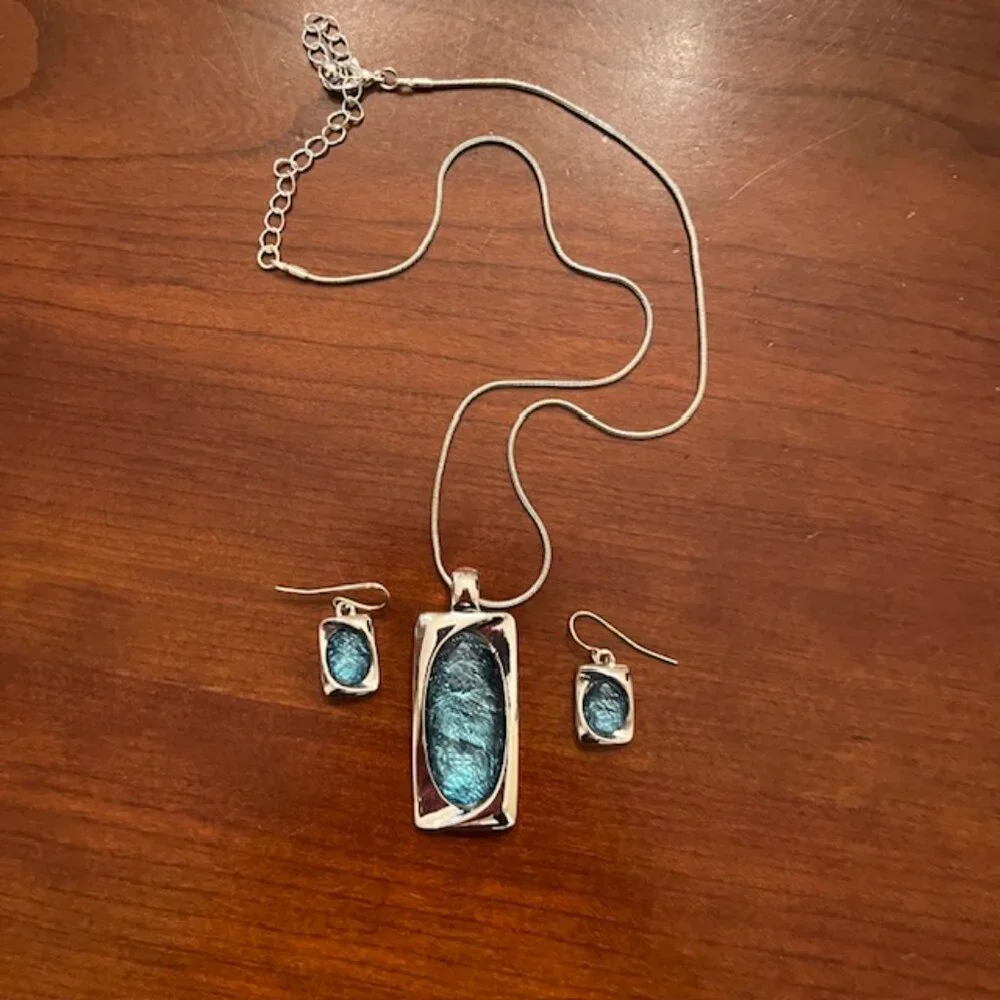 Aqua blue glass pendant and silver tone chain with matching earrings